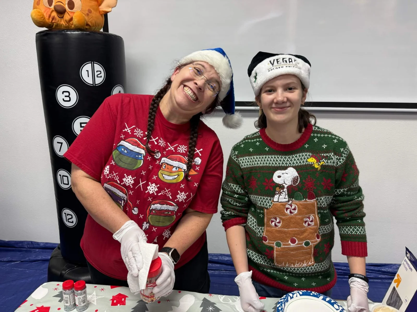 Engage team members wearing festive sweaters at the holiday craft table