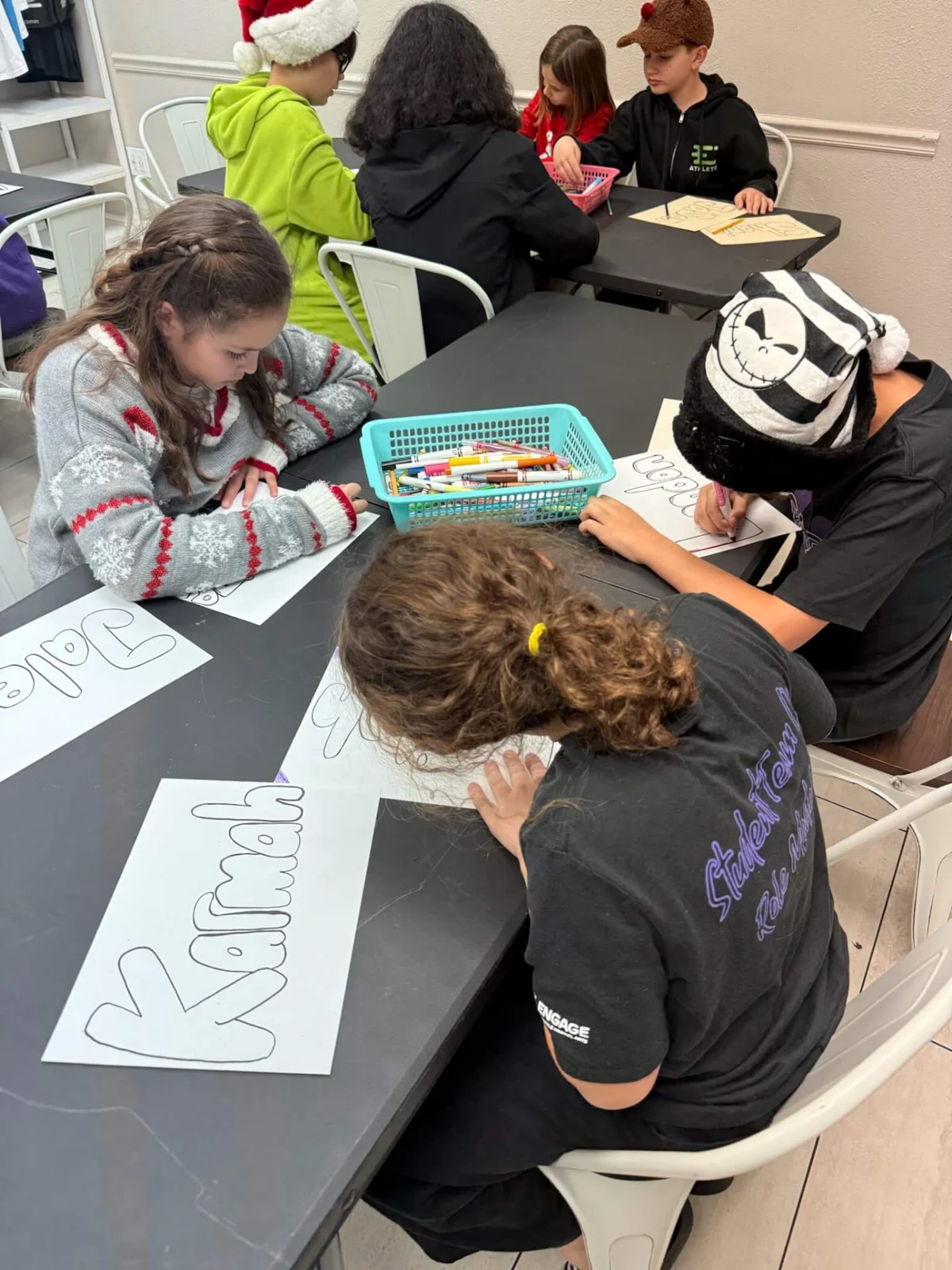 Children creating winter crafts together at Engage in Henderson