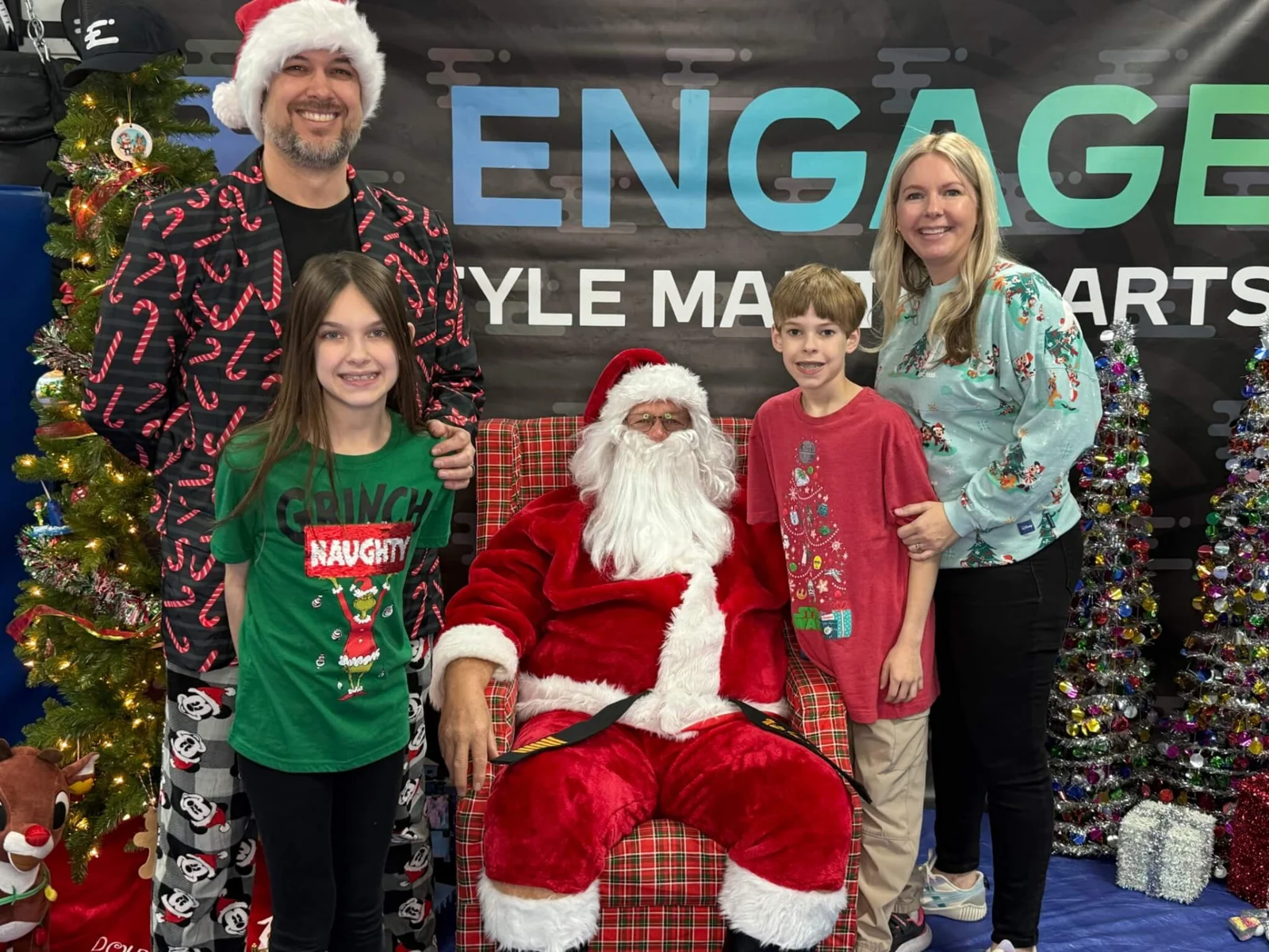 Family posing with Big Master Santa at Engage Lifestyle Martial Arts in Henderson